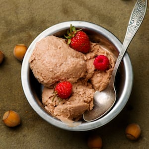 A Bowl of Nutella Ice Cream with Hazelnuts and Raspberries
