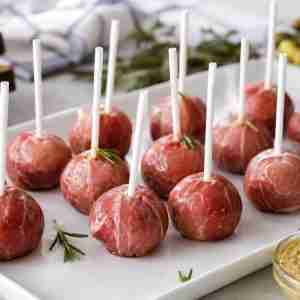 Westphalian Ham Lollipops with Black Forest ham mousse, rosemary, horseradish, and German party platter garnish