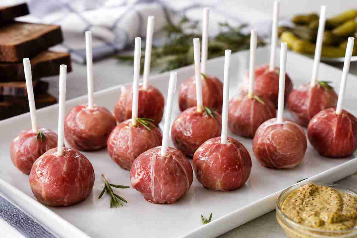 Westphalian Ham Lollipops with Black Forest ham mousse, rosemary, horseradish, and German party platter garnish